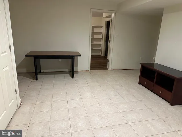 a view of an empty room and fire place