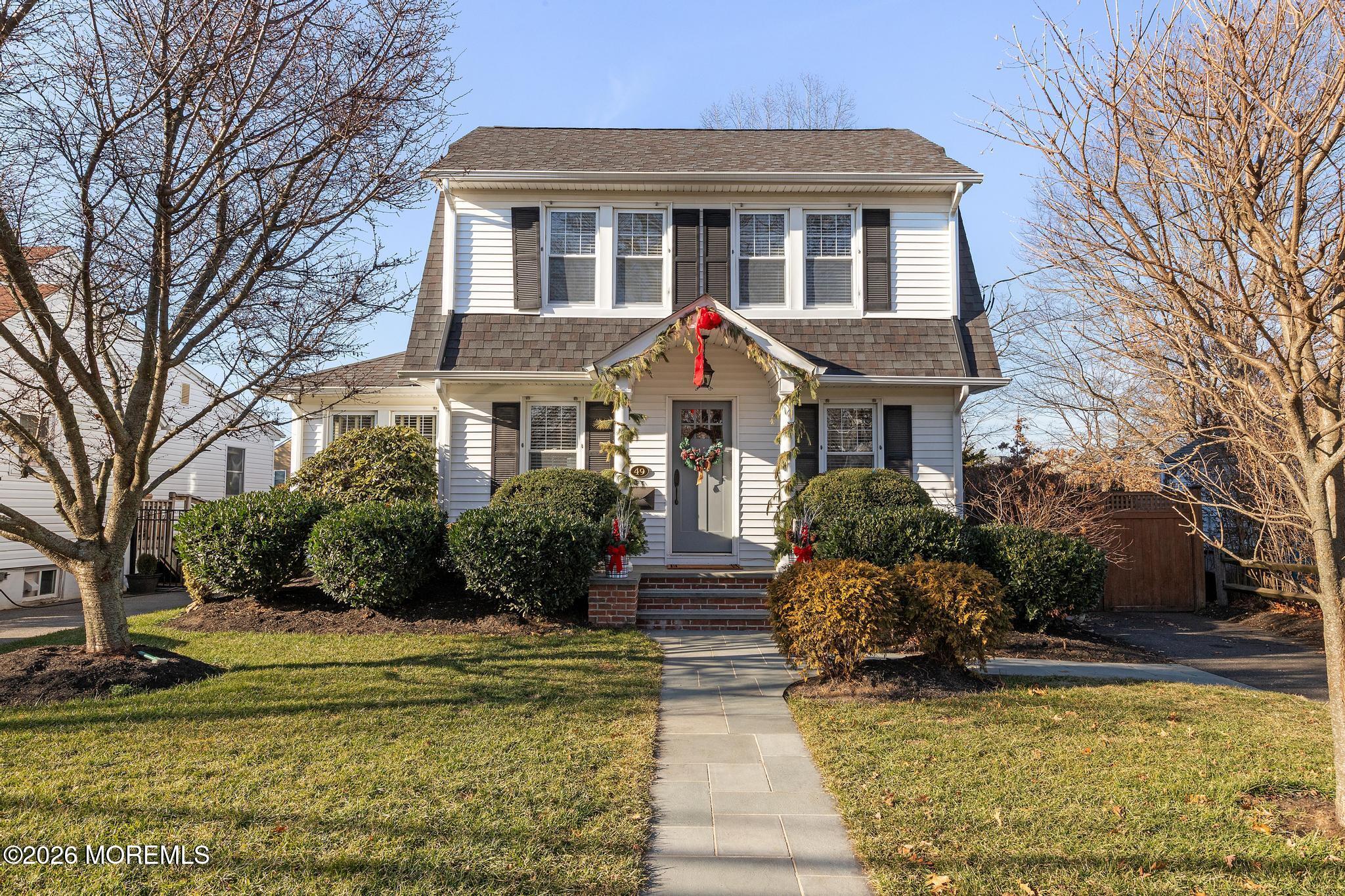 a front view of house with yard and green space