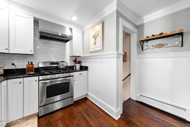 a kitchen with a refrigerator stove and wooden cabinets