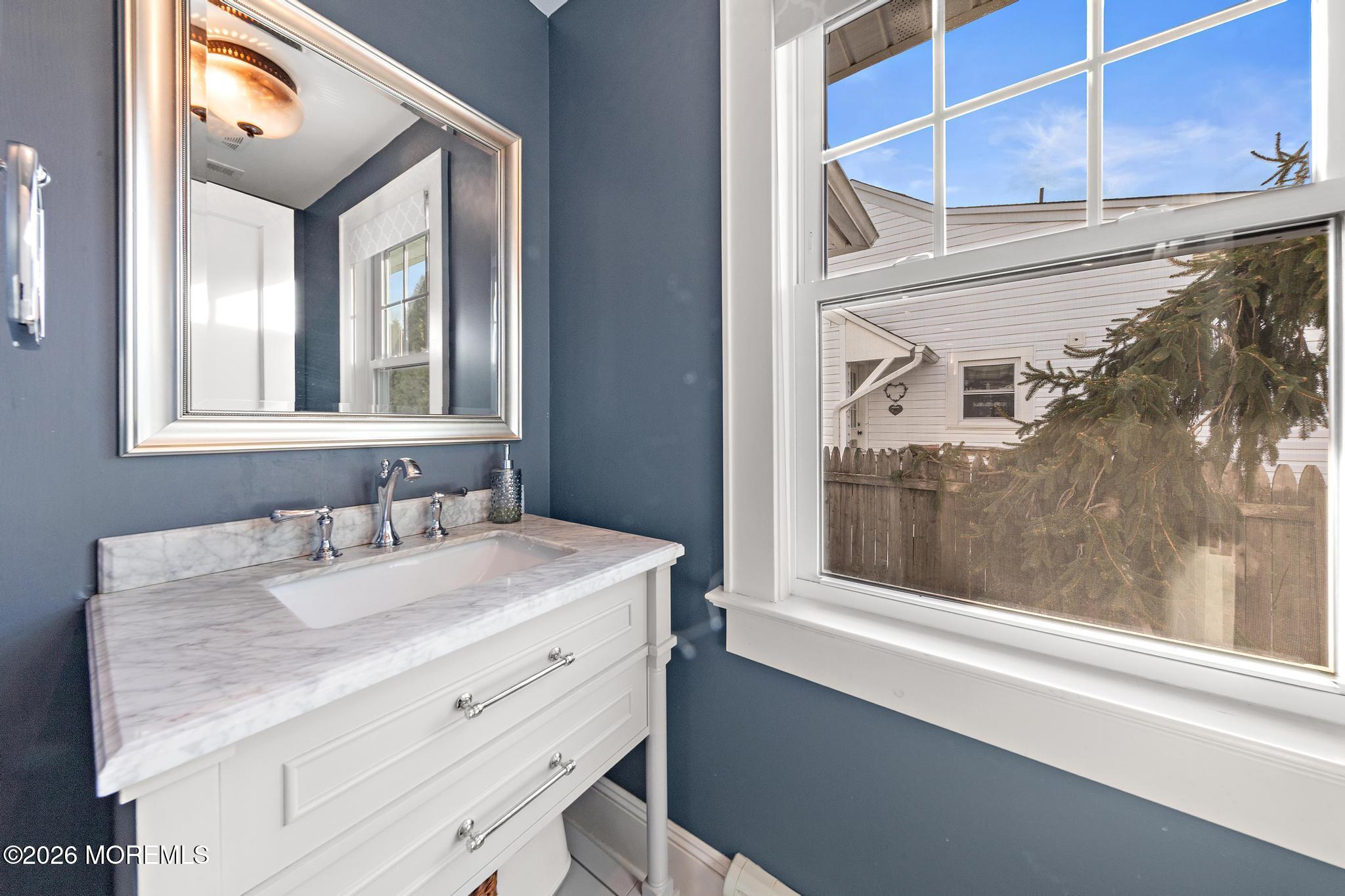 49 Jackson Street Fair Haven, NJ 07704 - Photo 13 of 42 a bathroom with a sink and a mirror