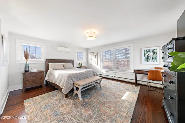 a spacious bedroom with a bed and a couch