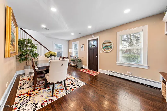 a living room with furniture a rug and a large window