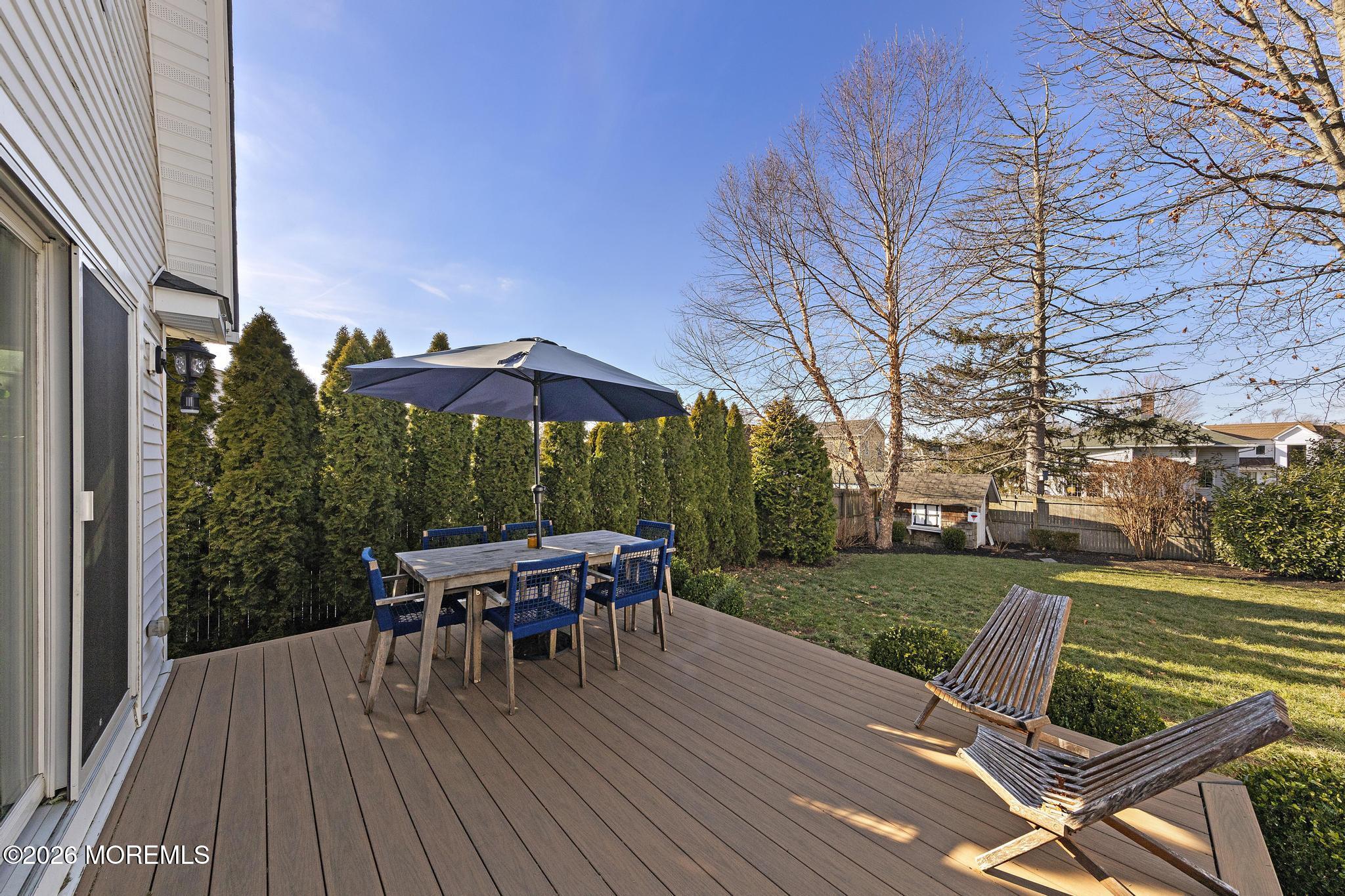 49 Jackson Street Fair Haven, NJ 07704 - Photo 36 of 42 a view of a patio with table and chairs under an umbrella with wooden floor