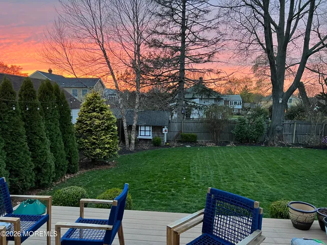 a view of a backyard with sitting area