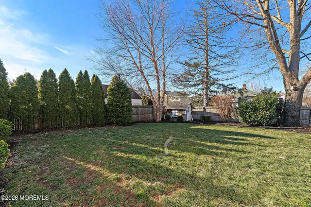 a view of a field with trees around
