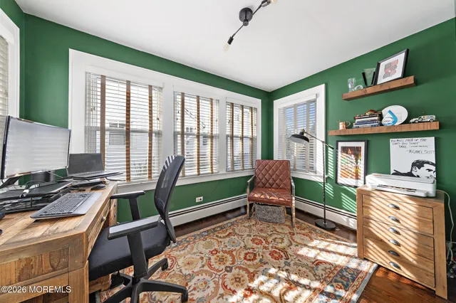 a living room with furniture fireplace and a large window