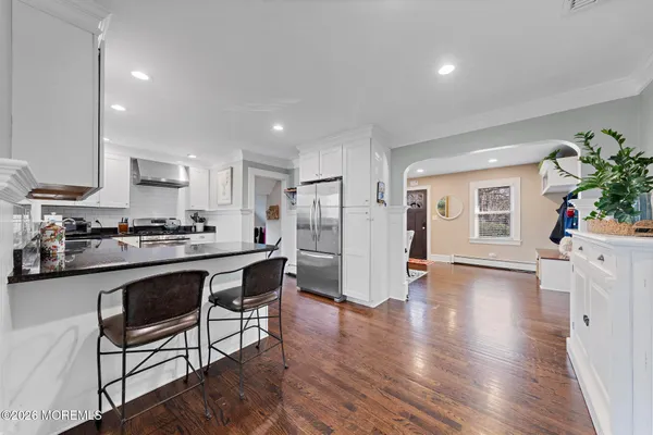 a kitchen with stainless steel appliances granite countertop a refrigerator and a stove top oven