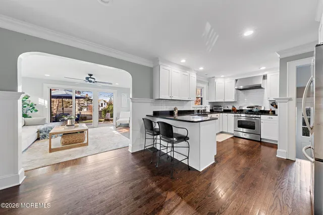 a kitchen with a refrigerator and a stove top oven