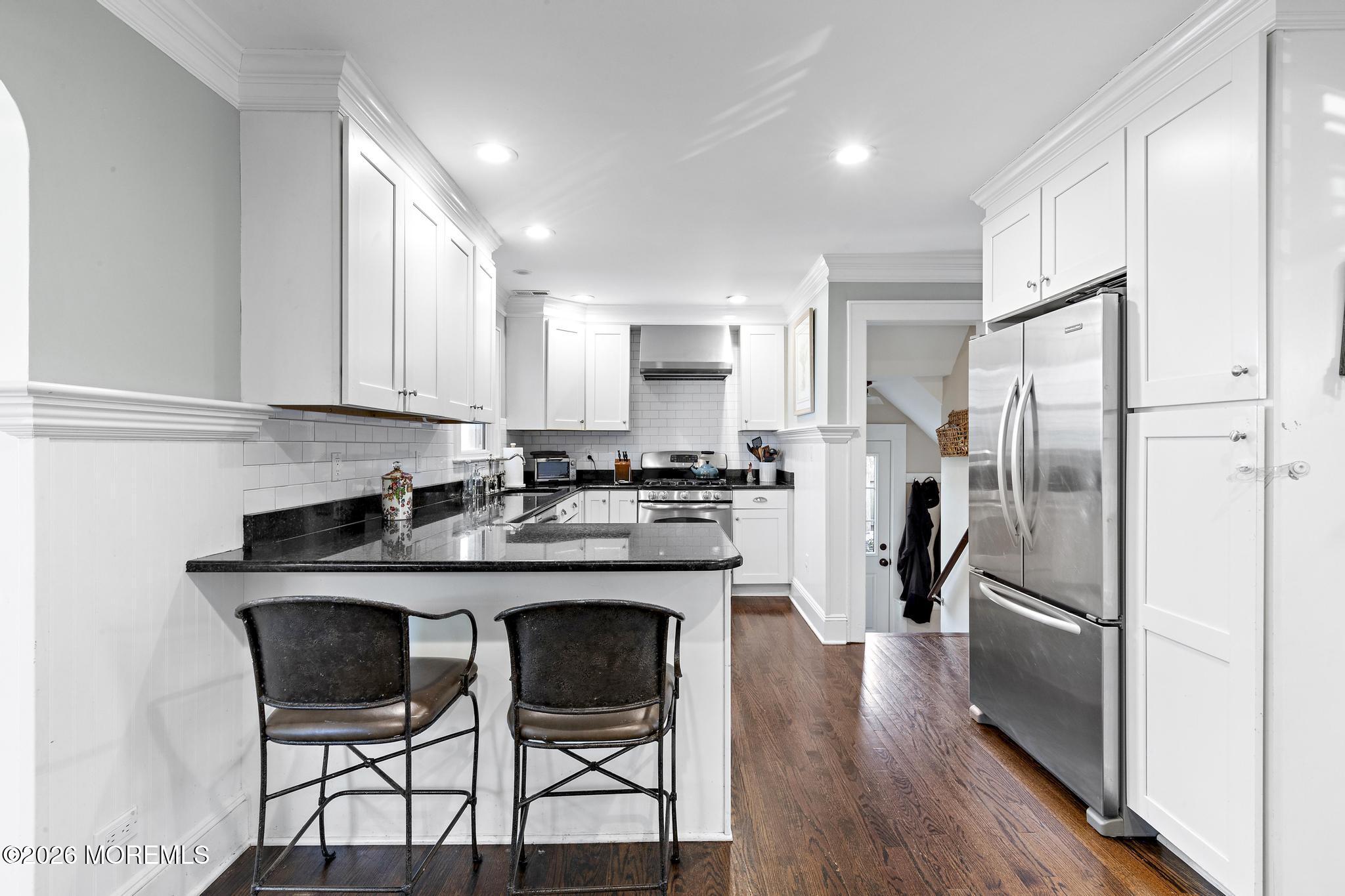 49 Jackson Street Fair Haven, NJ 07704 - Photo 9 of 42 a kitchen with stainless steel appliances granite countertop a dining table chairs refrigerator and sink