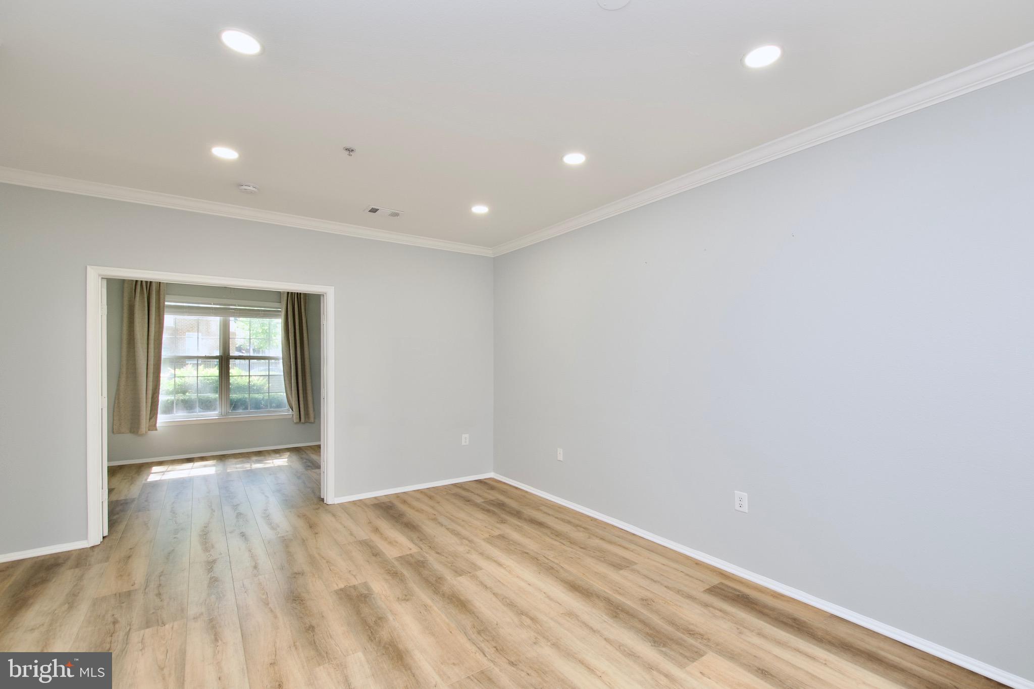3003 Nicosh Circle, Unit 3106 Falls Church, VA 22042 - Photo 11 of 25 a view of empty room with wooden floor and fan