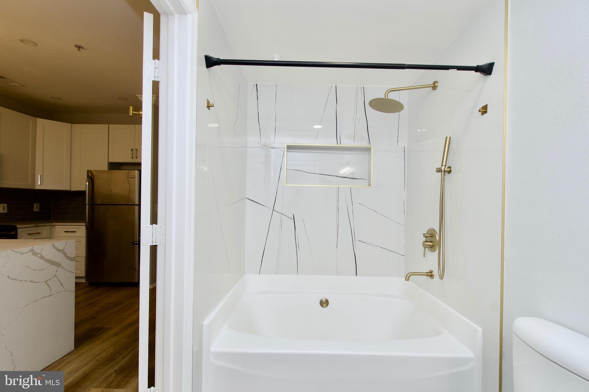 3003 Nicosh Circle, Unit 3106 Falls Church, VA 22042 - Photo 21 of 25 a bathroom with a bathtub and a shower