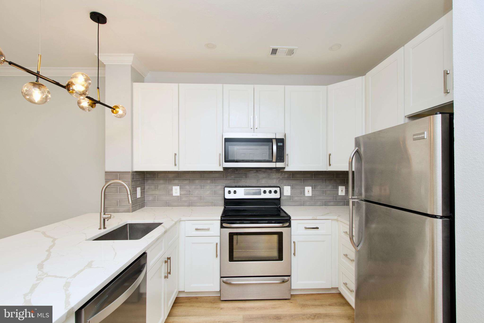 3003 Nicosh Circle, Unit 3106 Falls Church, VA 22042 - Photo 5 of 25 a kitchen with a refrigerator sink and stove