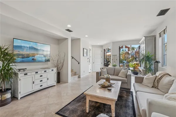 a living room with furniture and a painting on the wall