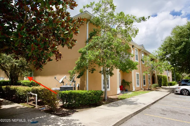 a couple of cars parked in front of a house
