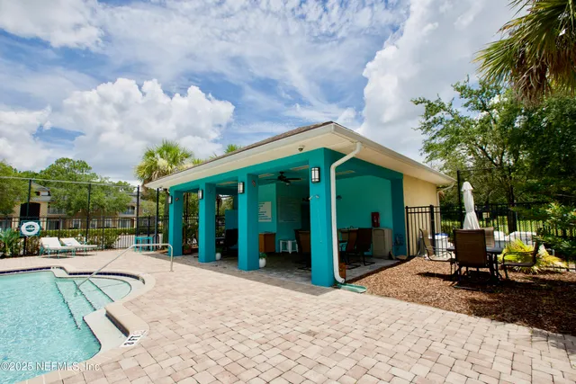 a view of a house with backyard porch and sitting area