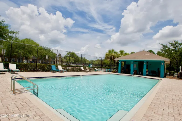 a view of a house with swimming pool and sitting area