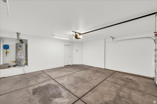 5875 Challenger Way St. George, UT 84790 - Photo 18 of 18 Spacious garage featuring a concrete floor, bright overhead lighting, and an automatic garage door opener