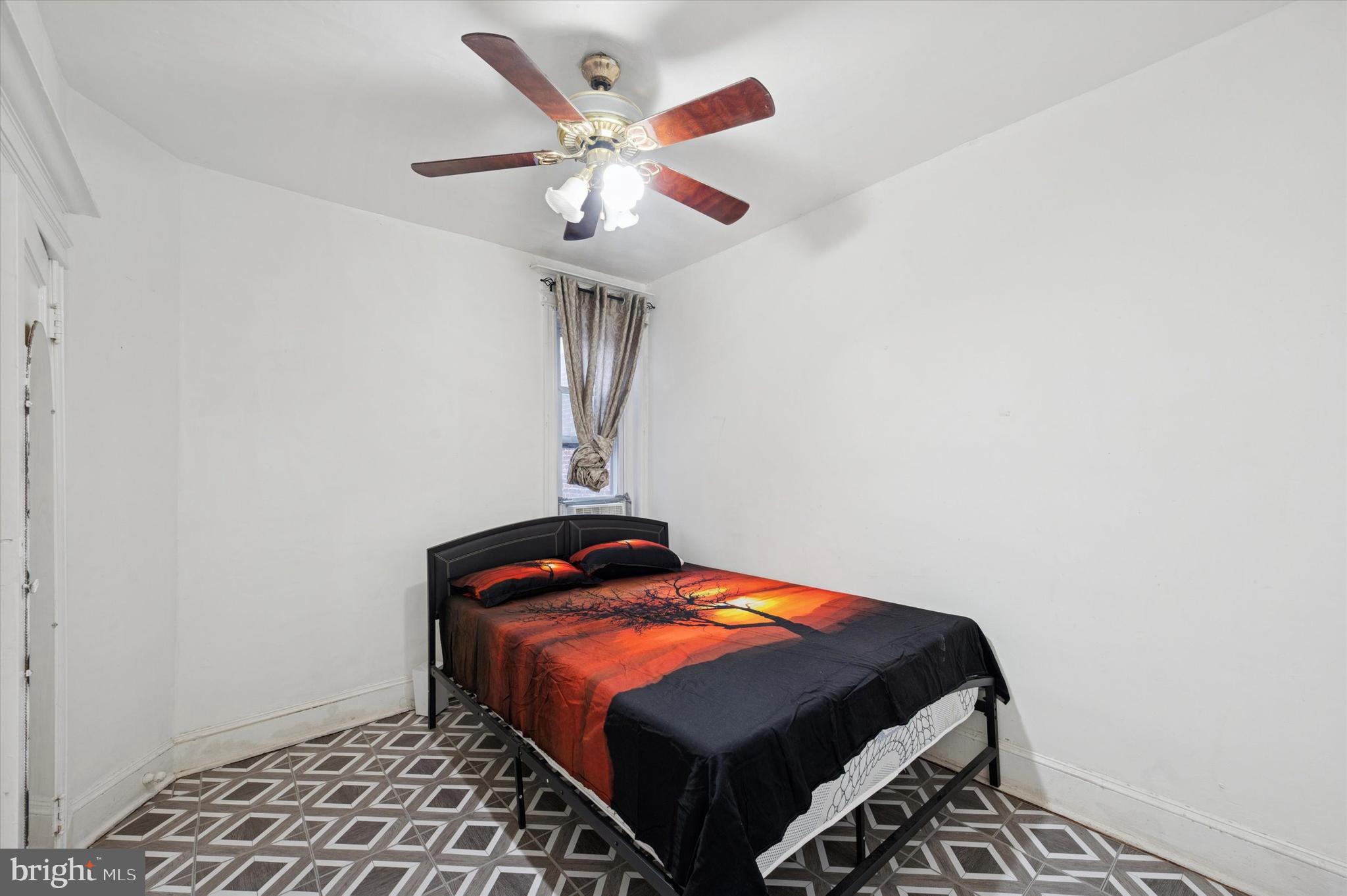 6105 Locust Street Philadelphia, PA 19139 - Photo 11 of 15 a bedroom with bed and a window