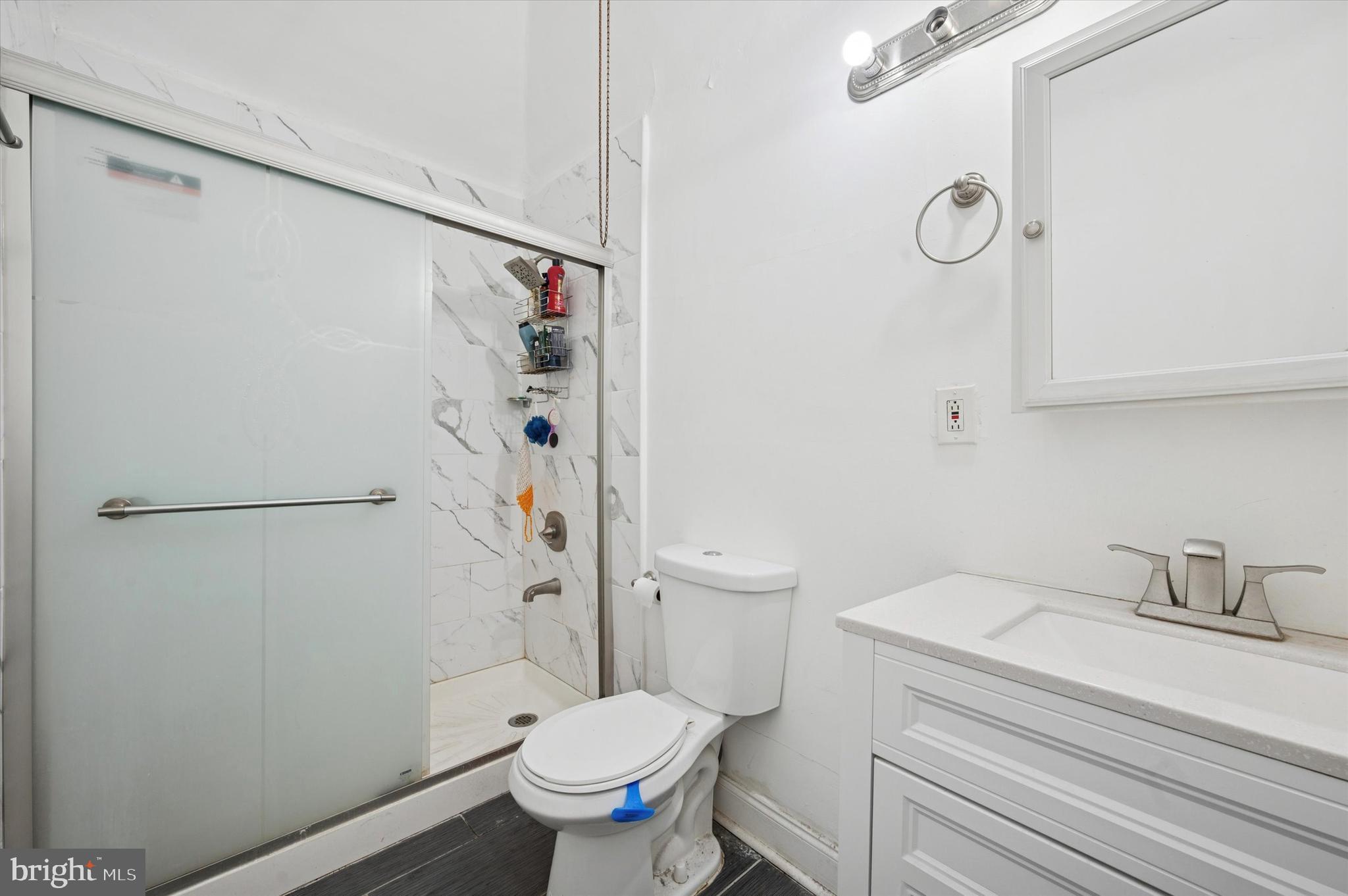 6105 Locust Street Philadelphia, PA 19139 - Photo 13 of 15 a bathroom with a sink a toilet and shower