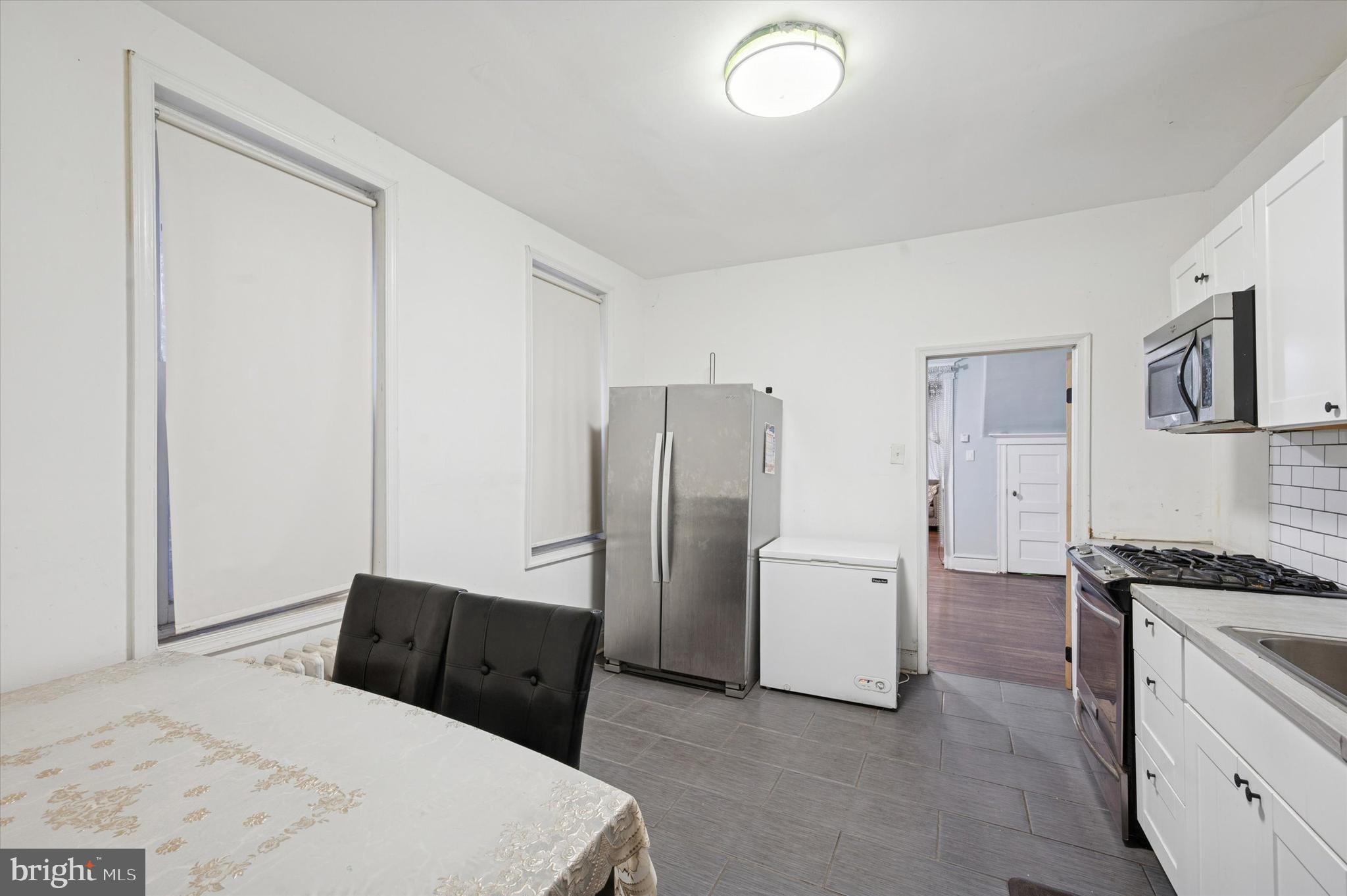 6105 Locust Street Philadelphia, PA 19139 - Photo 7 of 15 a kitchen with a refrigerator and white cabinets