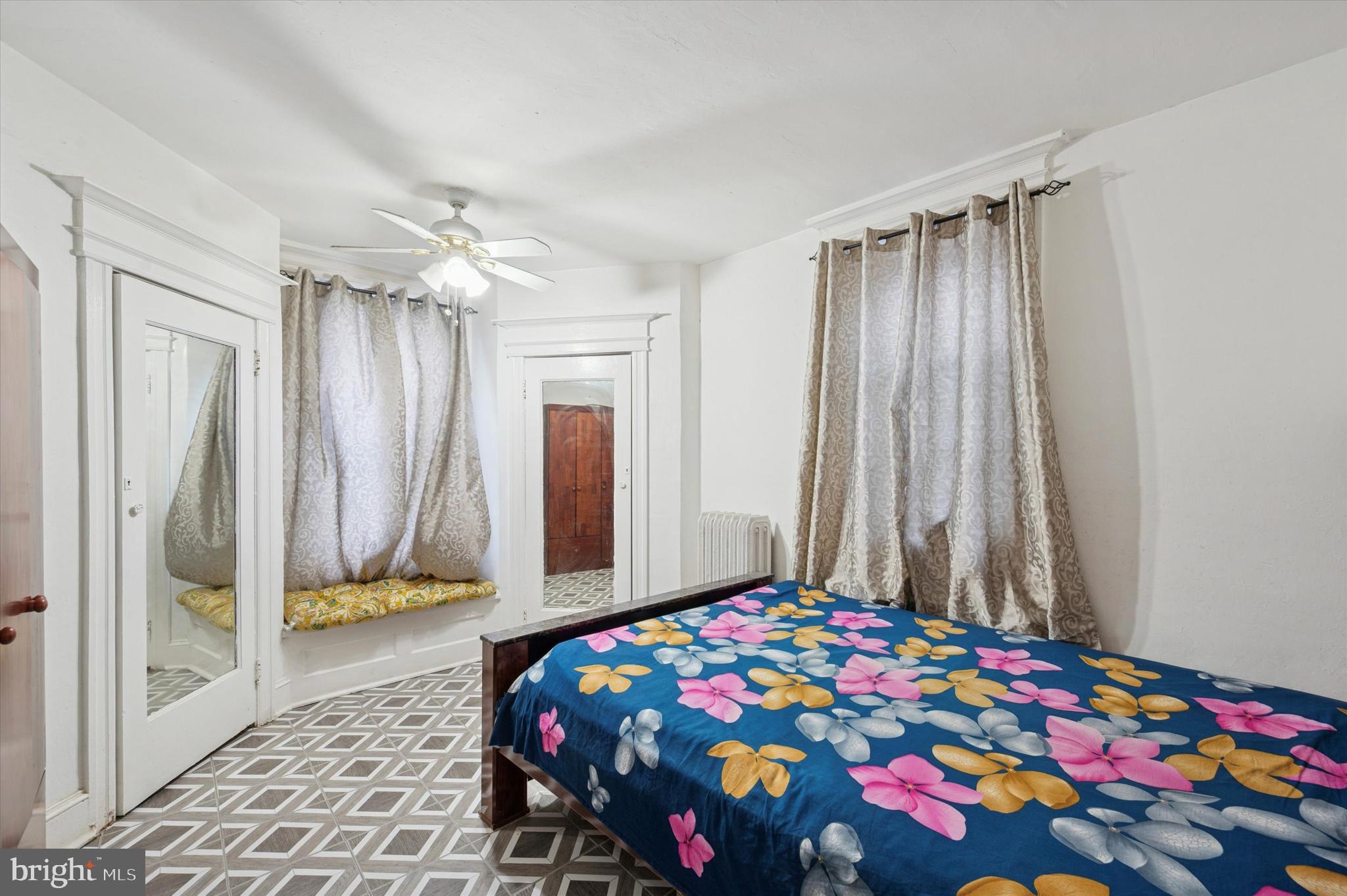 6105 Locust Street Philadelphia, PA 19139 - Photo 9 of 15 a bedroom with a bed and a chandelier