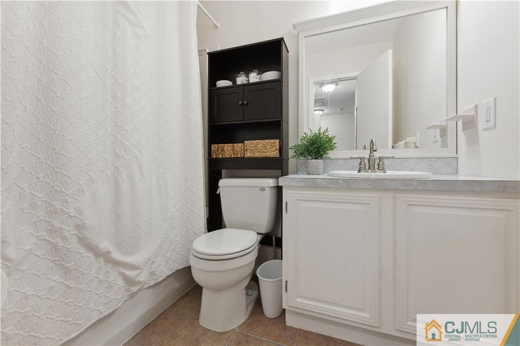 11 Kyle Street Manville, NJ 08835 - Photo 14 of 16 a bathroom with a sink and a toilet