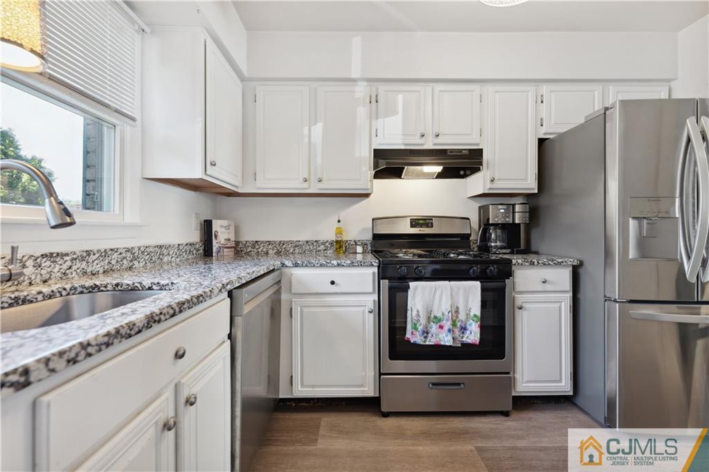 11 Kyle Street Manville, NJ 08835 - Photo 5 of 16 a kitchen with granite countertop white cabinets and stainless steel appliances