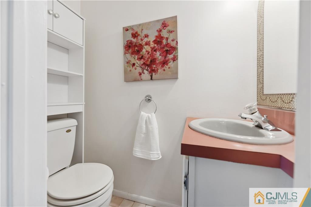 11 Kyle Street Manville, NJ 08835 - Photo 9 of 16 a bathroom with a toilet a sink and a mirror