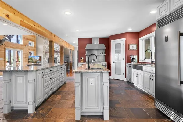 a kitchen with stainless steel appliances granite countertop a stove and a refrigerator