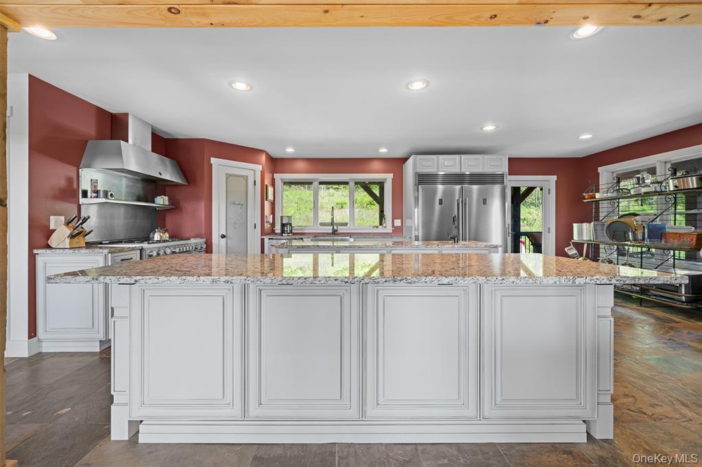 535 County Rte 22 Parish, NY 13131 - Photo 14 of 35 a kitchen with stainless steel appliances kitchen island granite countertop a stove and a sink