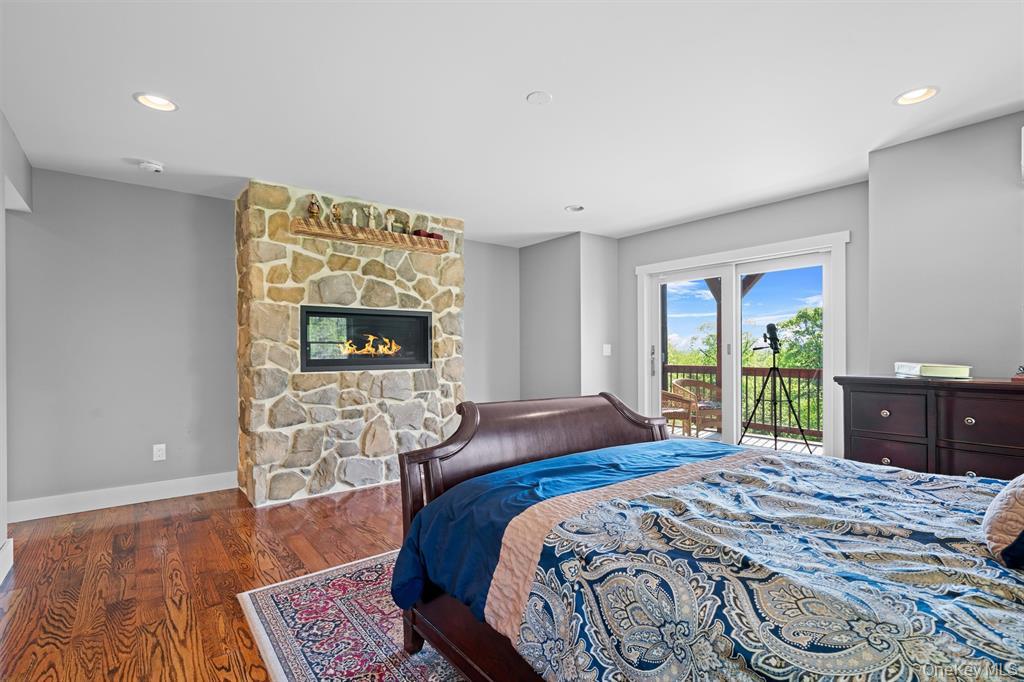 535 County Rte 22 Parish, NY 13131 - Photo 20 of 35 a bedroom with a bed and a fireplace