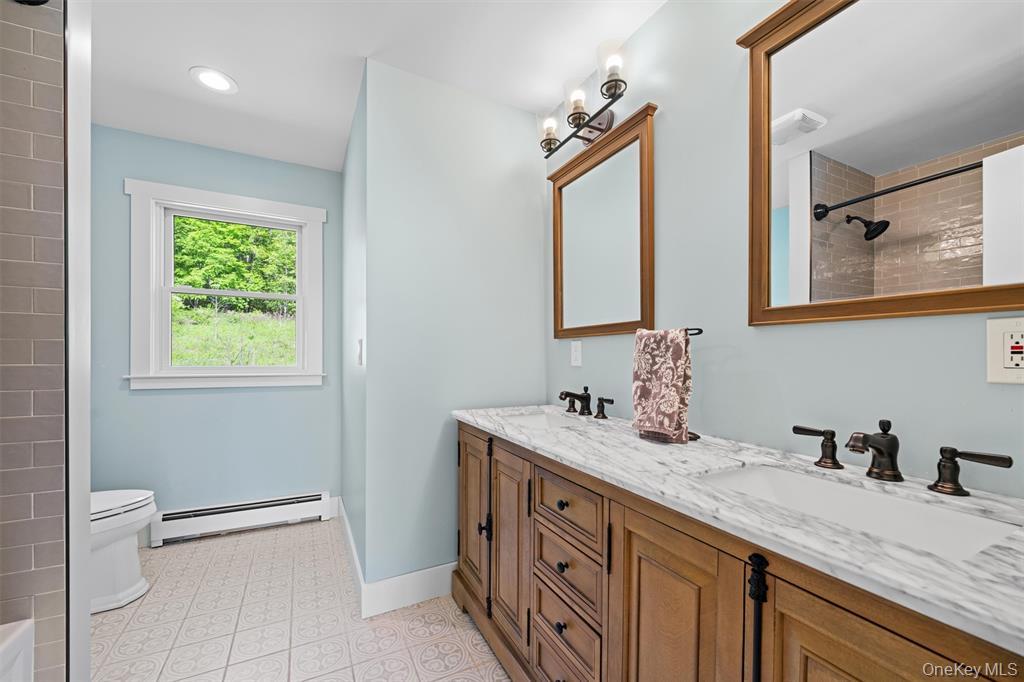 535 County Rte 22 Parish, NY 13131 - Photo 27 of 35 a bathroom with a granite countertop sink a toilet and a mirror