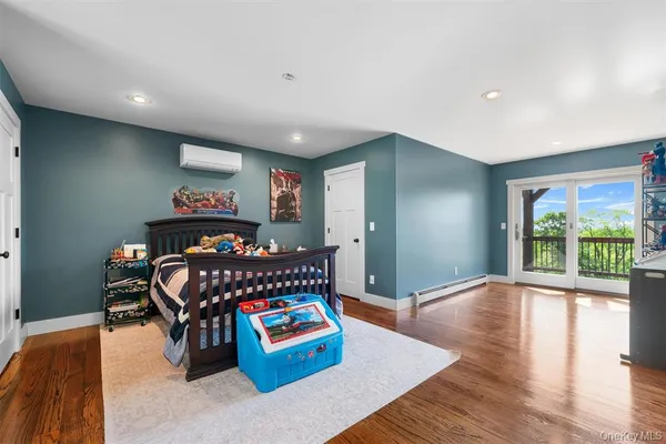 a view of a living room with furniture and wooden floor