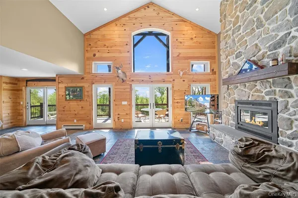 a living room with furniture fireplace and a large window