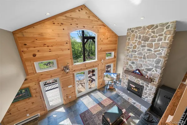 a living room with furniture a flat screen tv and a fireplace