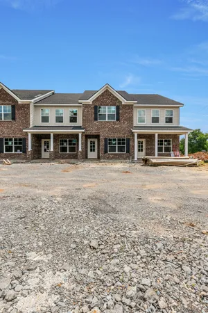 a front view of a building with a yard