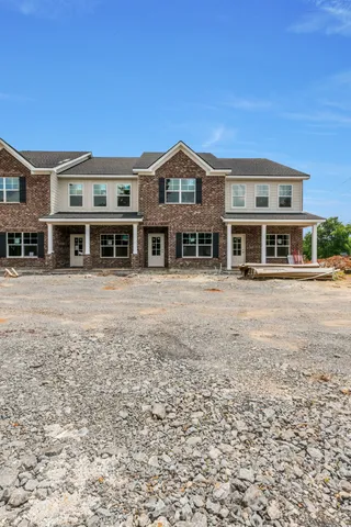 a front view of a building with a yard