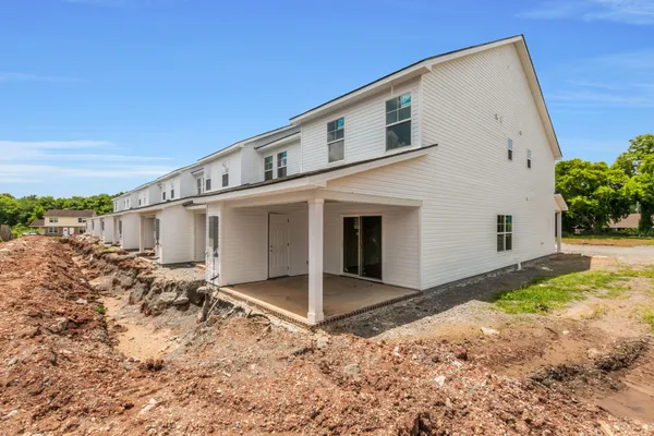 a view of a white house with a yard