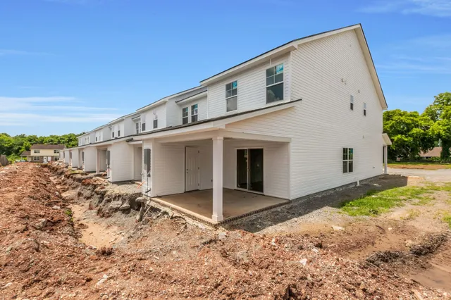 a view of a white house with a yard
