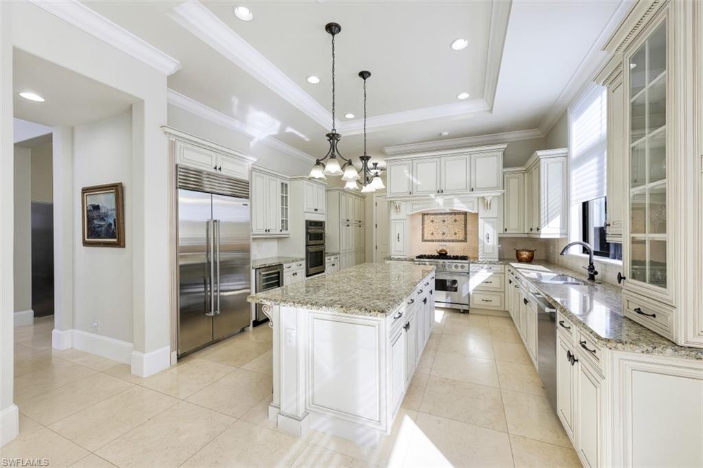 a view of a kitchen center island cabinets and stainless steel appliances