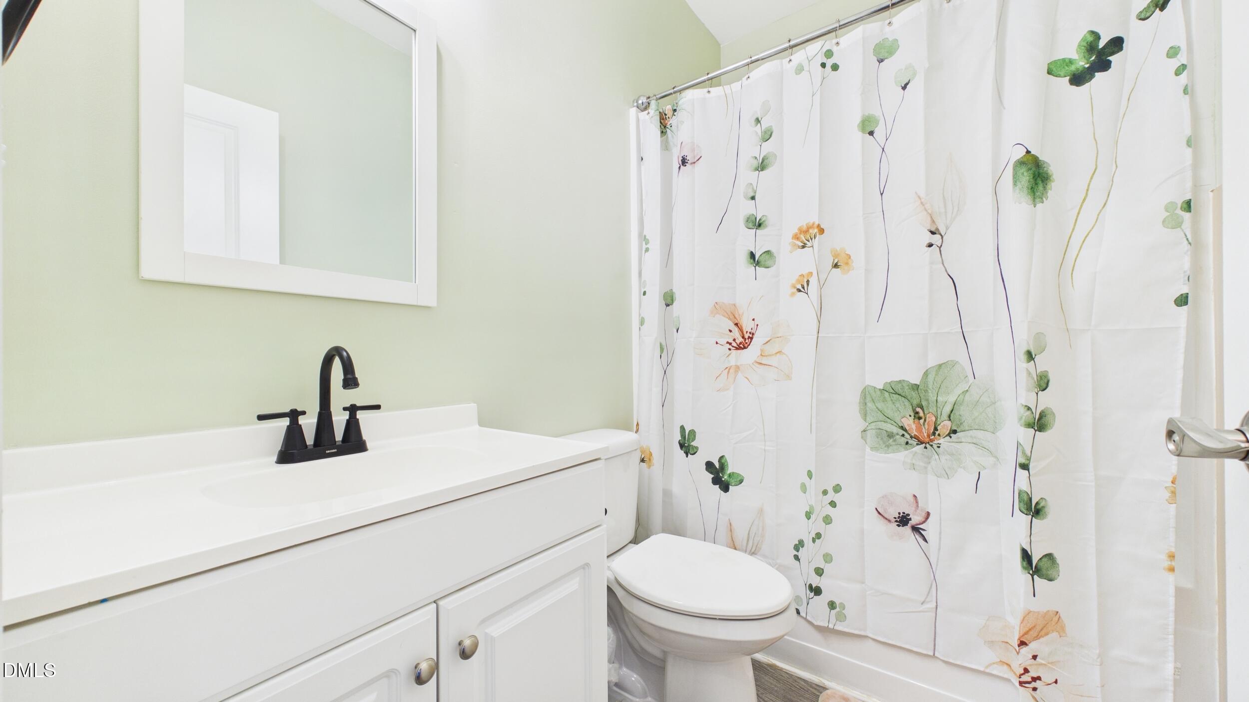 5930 Old 421 Road Liberty, NC 27298 - Photo 26 of 42 a bathroom with a sink a toilet and a shower curtain