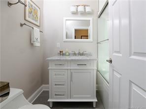 18 William Street, Unit WEST Greenwich, CT 06830 - Photo 13 of 21 a bathroom with a sink toilet vanity and a mirror
