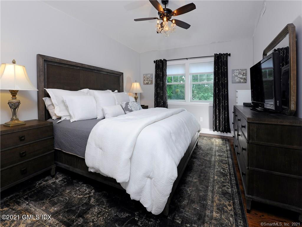 18 William Street, Unit WEST Greenwich, CT 06830 - Photo 8 of 21 a bed room with a bed window and a television