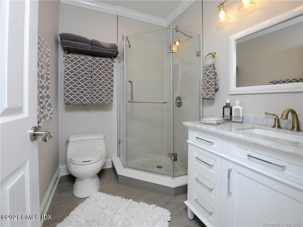 18 William Street, Unit WEST Greenwich, CT 06830 - Photo 9 of 21 a bathroom with a sink a toilet and shower