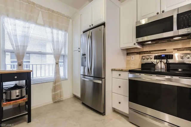 a kitchen with stainless steel appliances a refrigerator stove and microwave