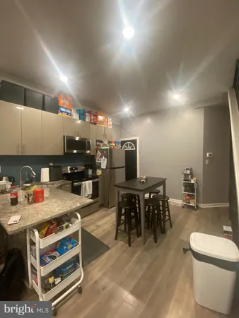 a kitchen with a table chairs and a stove