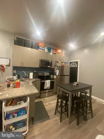 a kitchen with stainless steel appliances kitchen island granite countertop a sink and cabinets