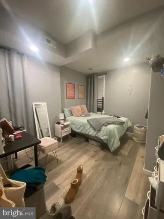 a bedroom with furniture and a chair