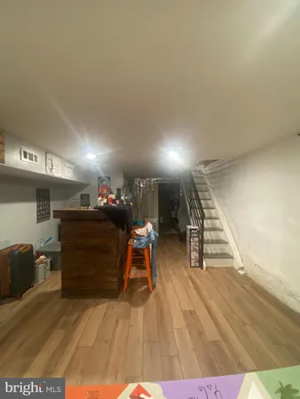 a room with wooden floor and stairs