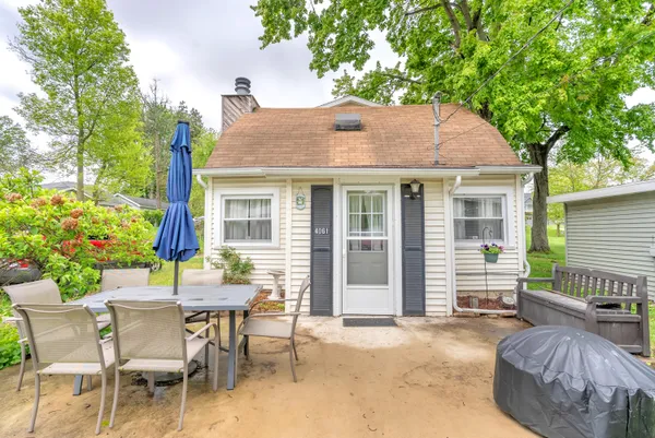 a view of a house with a backyard and sitting area